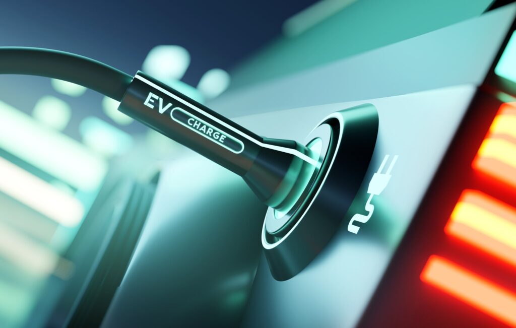 Cool Your Electric Motors with SLIC | Engineered Fluids EV charging cord plugged into charger port. Cool Your Electric Motors with Single-Phase Liquid Immersion Cooling