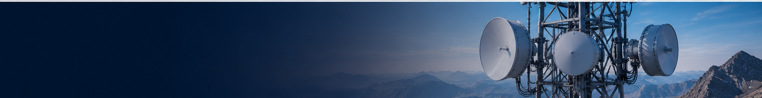 Telecommunications tower with large satellite dishes against a blue sky and distant mountains.