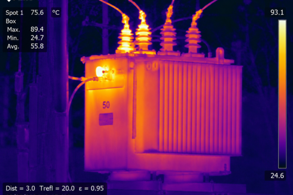 Infrared image of a power transformer with hot spots, showing temperatures around 75–89°C and a FLIR display on the left.